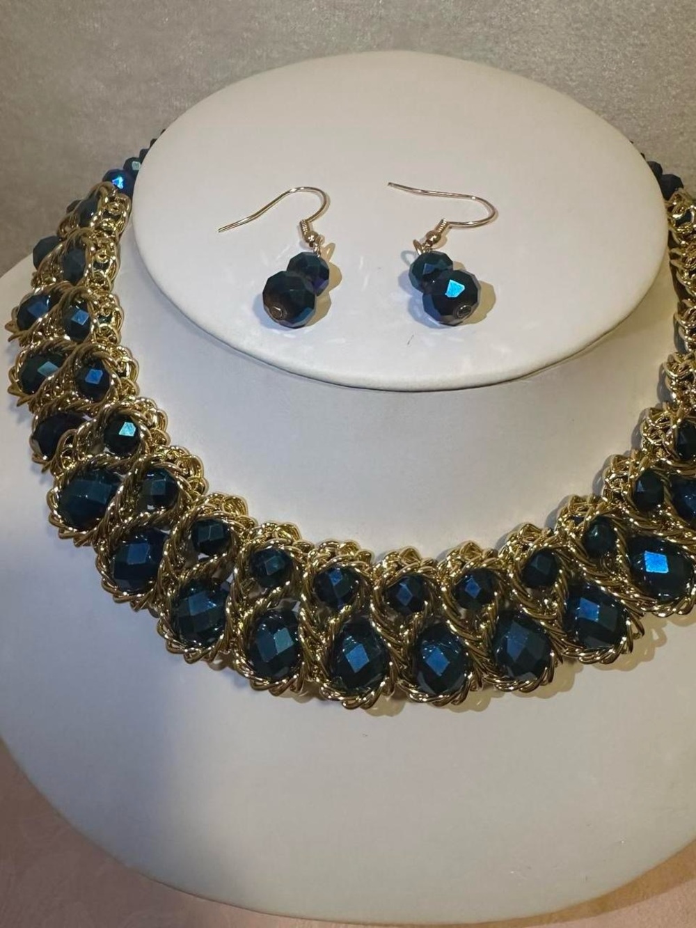 Gold tone blue bead necklace and earrings set.